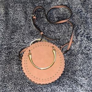 Mauve round crossbody with gold hardware. New